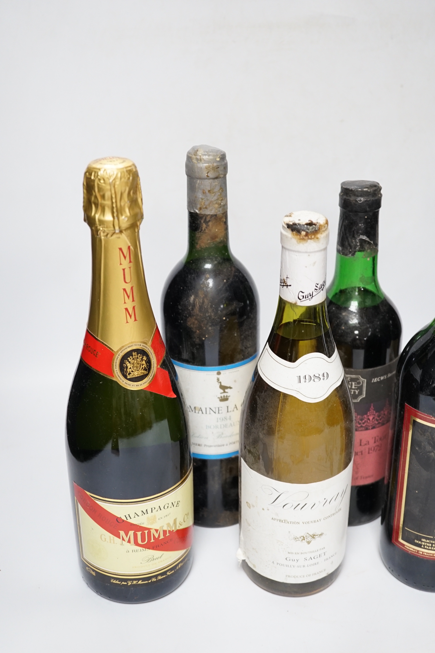 Five various bottles of wine to include Chateau La Tour St. Bonnet 1972, Vouvray 1989, Domaine La Grave 1984, Saint Emilion, Chateau Thieuley 1984 and a bottle of Mumm Champagne